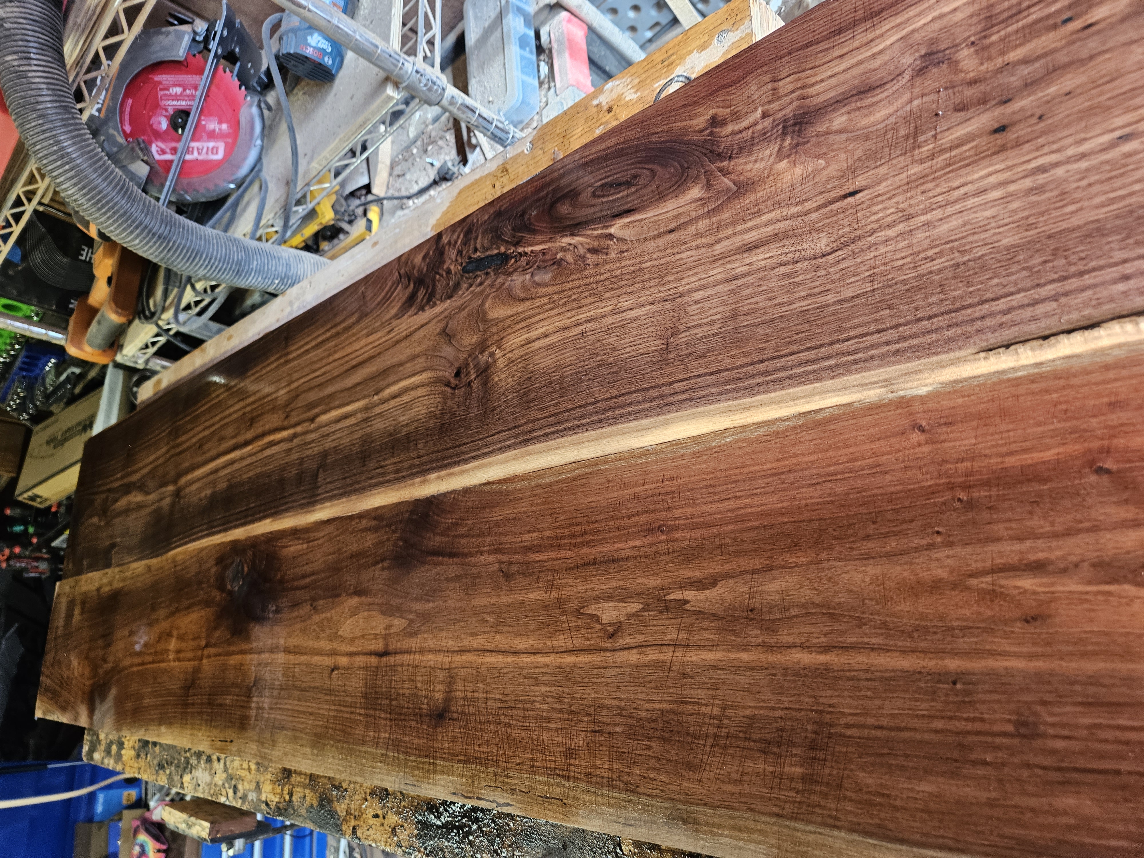 Rough walnut boards laid out on the bench